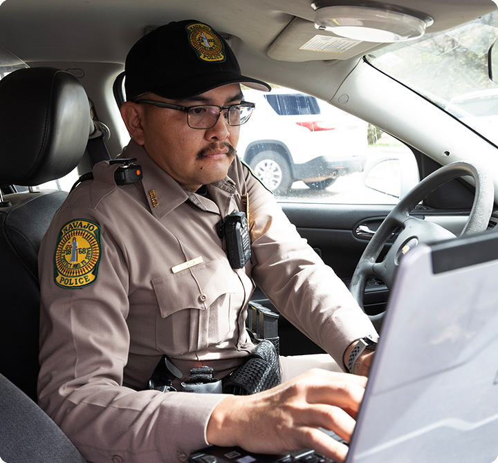 Officer using laptop in his vehicle