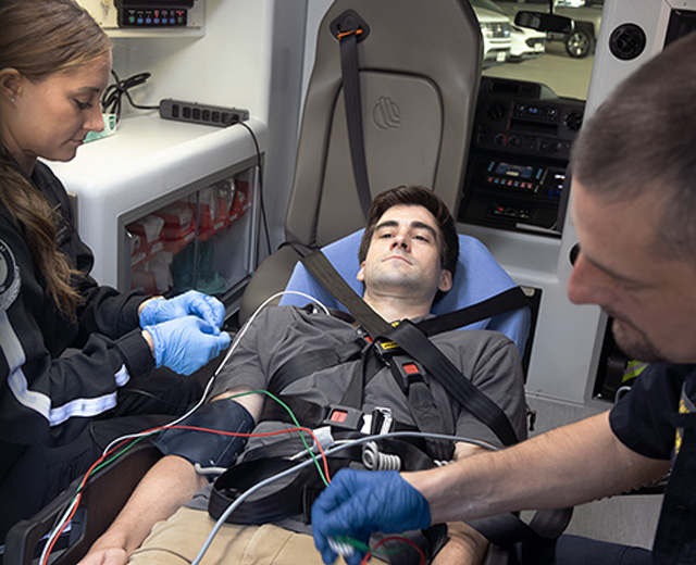 EMS workers and patient in vehicle