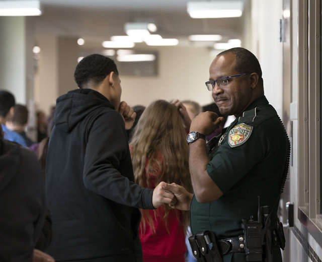 Police officer in school hallway