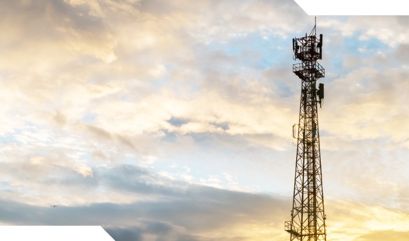 Closeup of a cell tower with a sunset background